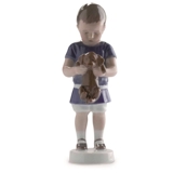 Boy holding a dog in front of him, Ole. Bing & Grondahl figurine no. 1747 or 422