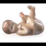 Pludrende baby liggende på ryggen, Royal Copenhagen figur nr. 244