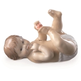 Pludrende baby liggende på ryggen, Royal Copenhagen figur nr. 244