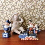 English: "Sitting baby with a swim cap/bonnet, Royal Copenhagen figure no. 247