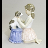 Girl trying bow tie on dog, Royal Copenhagen figurine no. 452