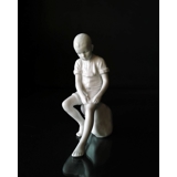 Boy sitting on stone, Royal Copenhagen figurine no. 520