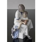 Mother with child taking off sock, Bing & Grondahl figurine no. 1829