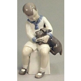 Boy sitting with Dog, Bing & Grondahl figurine No. 2201