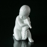 Child with sea horse holding it lovingly, Bing & Grondahl figurine no. 2396