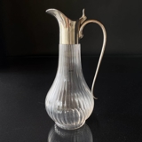 Ribbed glass pitcher with tight stainless steel lid.