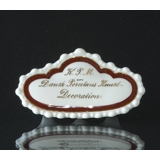 K.P.M. Dansk Porcelæns Kunstdecoration skilt