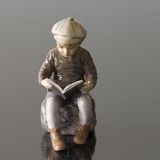 Boy sitting reading figurine Dahl Jensen, brown colours No. 1096