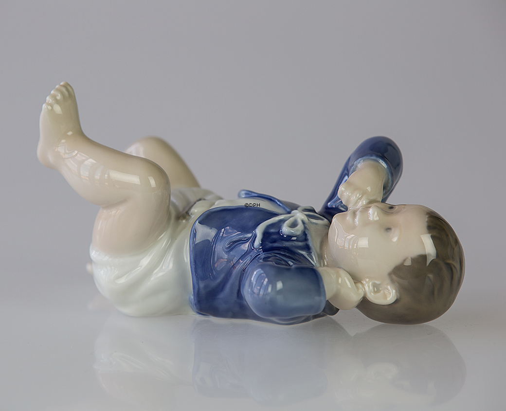 Baby som ligger på ryggen, Royal Copenhagen figur nr. 4669