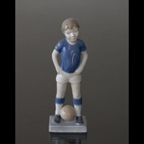 Boy playing football, Royal Copenhagen figurine no. 5657