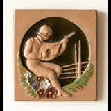 Plate with motif of man playing guitar, clay