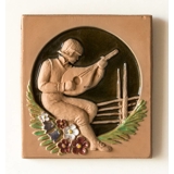 Plate with motif of man playing guitar, clay