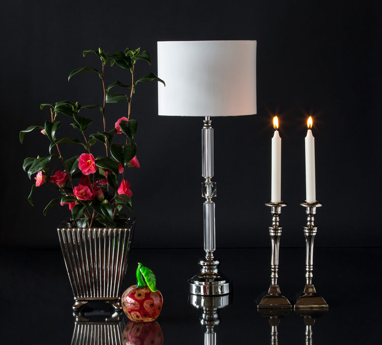 Large metal flower pot with glass apple, tablelamp and candlesticks