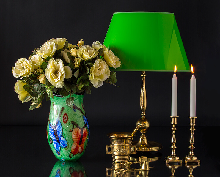 Green vase with butterflies that match the green lacquer lampshade on the brass lamp