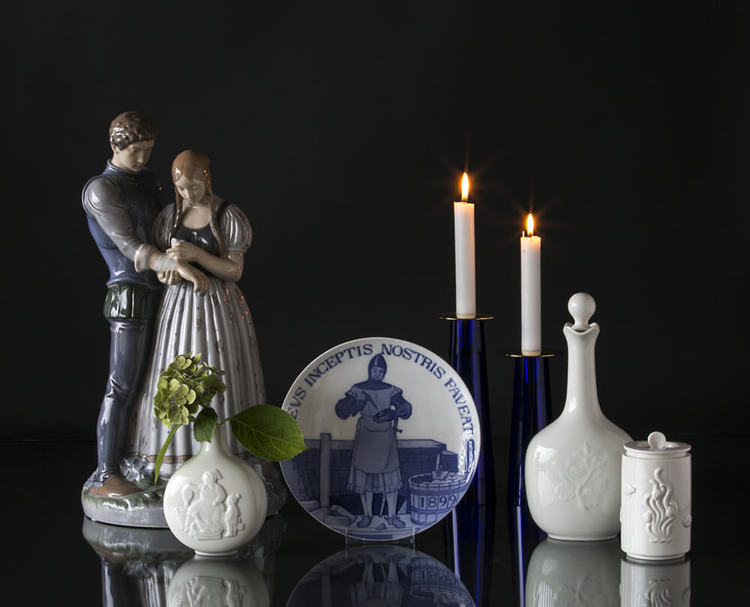 Figurine of Maid and Knight next to a masonic plate and Royal Copenhagen jars