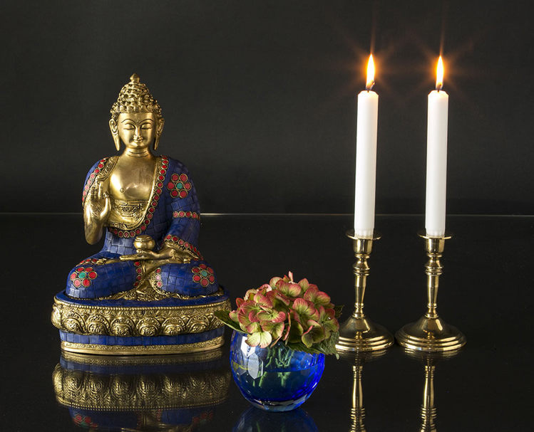 Blue Buddha statue with flowers